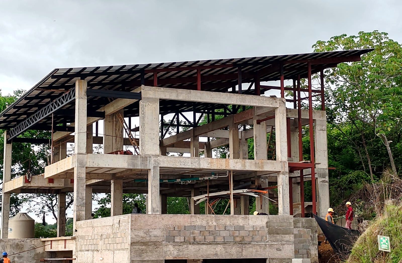Estructura de concreto de dos niveles con techo de acero en construcción